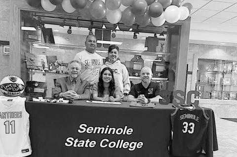 SSC Signing Courtesy Photo Point Guard Kelbey Parnacher from Latta High School has signed a basketball letter of intent to attend Seminole State College Seated: Coach Randy Wassam, Kelbey Parnacher, Latta Head Coach Clay Plunk Back Row: Kelbey’s parents