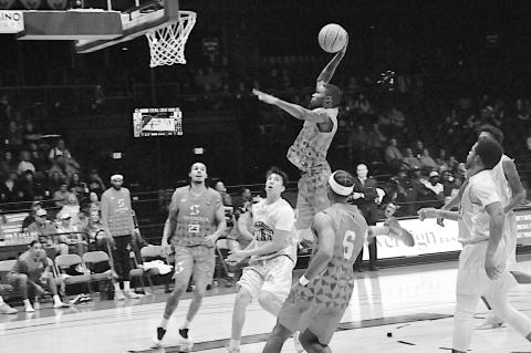 Potawatomi Fire Kam Williams flies in for the slam dunk Friday night against the Clutch. Staff Photo by Bill Anderson