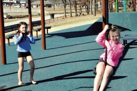 Sophia Hines and Tatum Batchelor, both barefoot and clad in shorts, ventured out Friday afternoon to swing and grab some sunshine at Boom Town. Should they do so again this weekend, their feet might be a little warmer, as temps in the 60s are in the forec