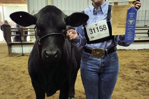 Molly Pruett (pictured at right) won her class at OYE with her Brangus heifer.