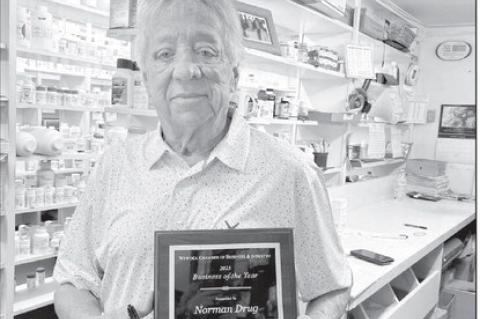 John Norman of Norman Drug in Wewoka holds the plaque he was presented with by the Wewoka Chamber of Business &amp; Industry for 100 years of service to the community. The award was presented at the Chamber’s banquet on March 30. (Courtesy photo)