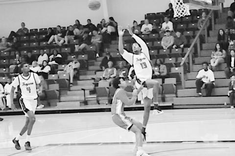 Seminole State Trojan Joseph Hunter catches the pass for the dunk Monday night. Staff Photo by Bill Anderson