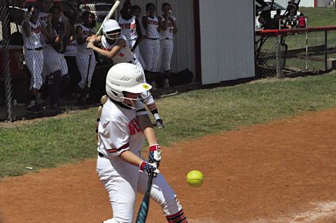 Wewoka Lady Tiger Sandi Simon knocks one out to the outfield Thursday at the Sasakwa Fast-Pitch Tournament. Staff Photo by Bill Anderson