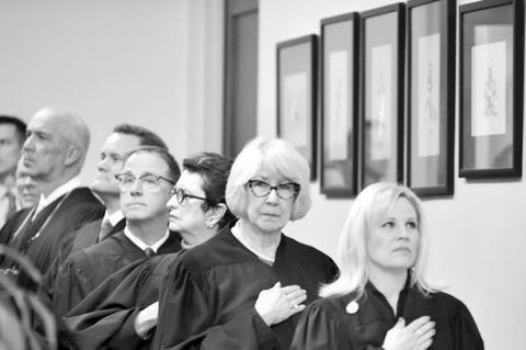 Justices of the Oklahoma Supreme Court stand before entering the House chamber in the Oklahoma State Capitol for the governor’s State of the State Address on Feb. 5, 2024. (Photo by Kyle Phillips/For Oklahoma Voice)