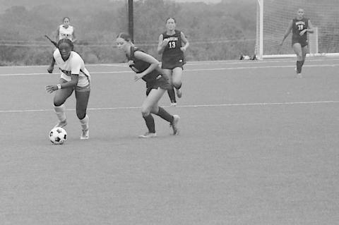 Seminole State Lady Trojan Kamora Haralson drives the ball down the field Sunday. Staff Photo by Bill Anderson