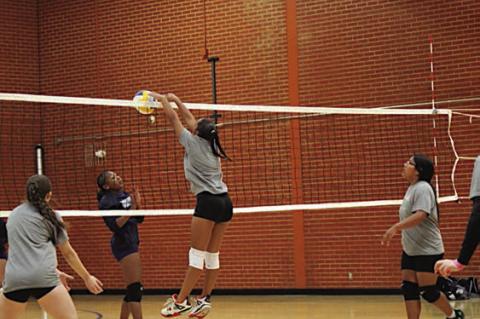 Seminole Lady Chieftain Laney Griffith goes up and over for the spike. Courtesy Photo by Jacque Sinor