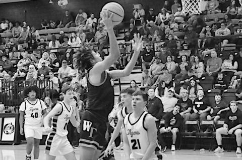Wewoka Tiger Nadim Bruner drives in for the basket Monday night. Staff Photo by Bill Anderson