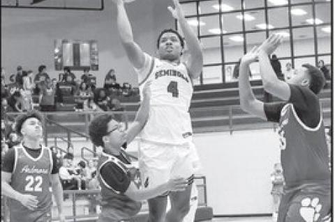Courtesy Photo by Glen Bryan Seminole Chieftain Donavin Garfield is able to get a shot off as he gets between two Ardmore players.