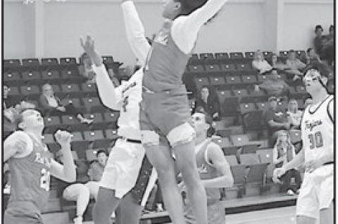 Seminole State Trojan Dylan Golightly fights off the Allen defender for the basket. Staff Photo by Bill Anderson