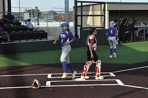 Bowlegs Lady Bison Kloe Oyler scores the run Thursday night at the LRC Tournament. Staff Photo by Bill Anderson