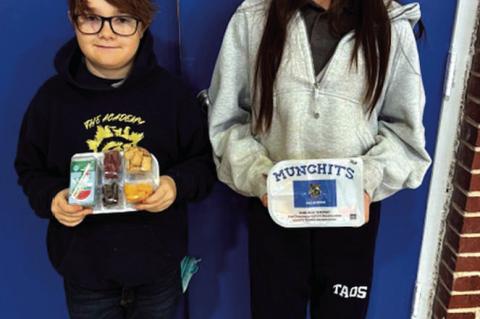 Pictured above are Academy of Seminole students Ryder Gurley and Kodi Lauderdale with samples of meals that are provided through a new partnership between the school and Feed the Children. (Photo courtesy of TAOS).