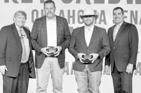 Oklahoma Farm Bureau President Rodd Moesel presents Sen. Grant Green and Rep. Trey Caldwell with 2025 OKFB Champion Awards along with OKFB Director of Public Policy Gage Milliman during the awards banquet at the 2025 OKFB annual meeting Saturday, Nov. 8, 