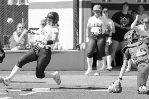 Seminole State Lady Trojan Mckenzier Cothran scores a run as the ball gets past the catcher Monday. Courtesy photo by Glen Bryan
