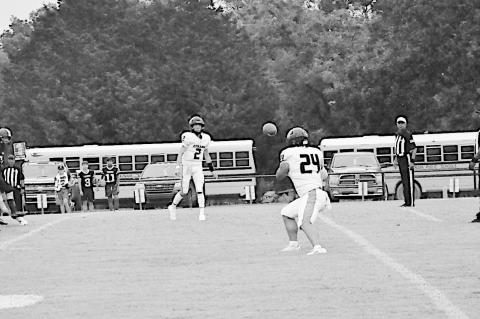 Staff Photo by Bill Anderson Konawa Tiger quarterback Moses Isaacs passes the ball to teammate Quentin Shaw Friday night.