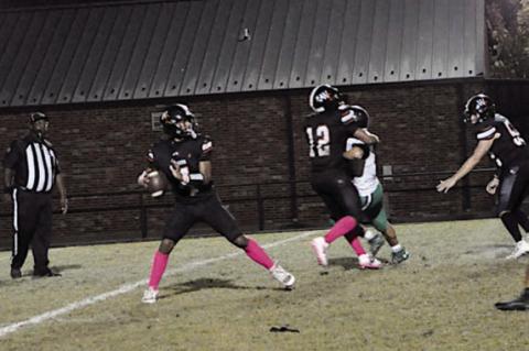 Wewoka Tiger quarterback Ladarius Woods drops back for a pass against Gore. Staff Photo by Bill Anderson