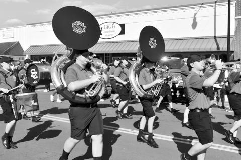 Right, the Seminole High School Marching Band, under the direction of Konnor Robertson, marches down Main Street Friday afternoon as part of the 2025 Seminole High School Homecoming parade. —Staff Photo by Andy Wilson