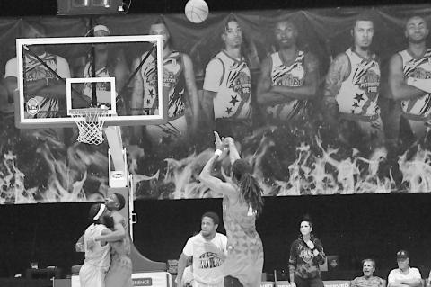 Potawatomi Fire Jay Mahone shoots the three from half court Friday night against San Antonio. Staff Photo by Bill Anderson