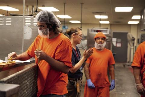 Prisoners are shown working in the kitchen at the Joseph Harp Correctional Center in Lexington. (Brent Fuchs/Oklahoma Watch)