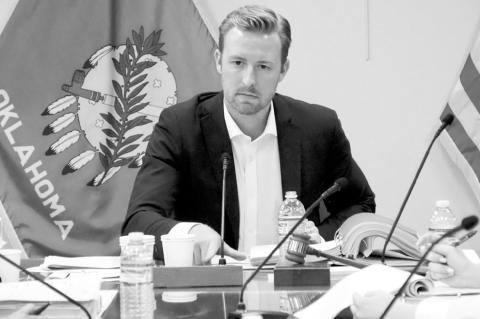 State Superintendent Ryan Walters sits at the head of the table during a meeting April 24 at the Oklahoma State Department of Education in Oklahoma City. Walters won’t face criminal prosecution over reports of explicit images being displayed on his offi