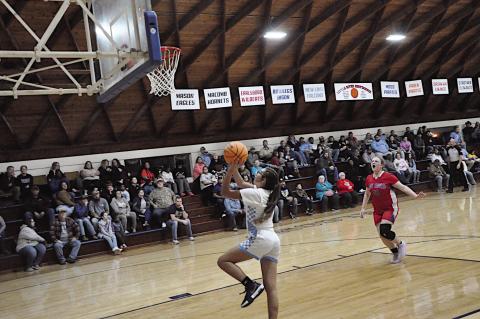 New Lima Falconette Jazzy Harjo gets the pass and goes up for the basket Thursday night. Staff Photo by Bill Anderson
