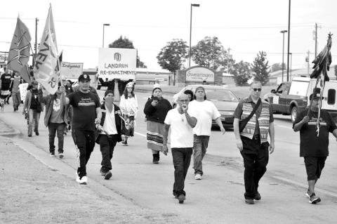 In this file photo from October 2022, a group of walkers make their way up Milt Phillips to raise awareness of Indigenous People. On May 5, Gov. Kevin Stitt vetoed a bill that would have allowed state funding for the Murdered and Missing Indigenous People