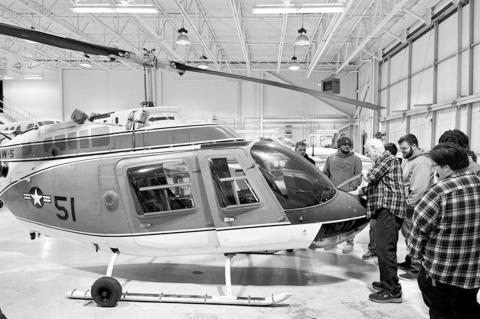 Gordon Cooper Technology Center students and staff observe their new helicopter, acquired through the Oklahoma Federal Surplus program. (Photo provided)