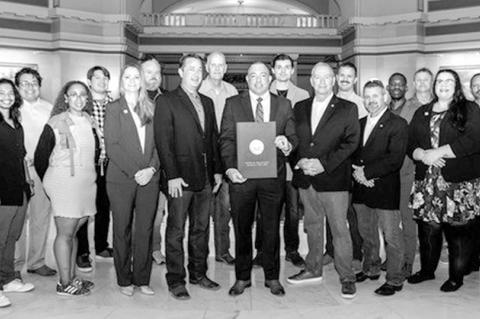 State Chief Information Officer Dan Cronin is joined by the OMES OK-ISAC and Oklahoma Cyber Command teams holding the proclamation for the 2025 Cybersecurity Awareness Month in Oklahoma. (Photo by Maddy Remington, OMES Outreach)