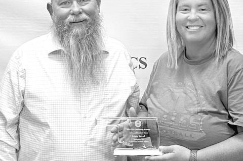 Seminole State College Vice President for Academic and Student Affairs Dr. Bill Knowles (left) presents Athletic Director Leslie Sewell (right) with a plaque recognizing her completion of the Advanced Leadership Track of the 2024-2025 Council on Student A