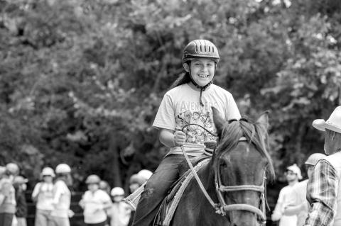 Camper Darius Gaines enjoys horseback riding at Camp Survivor, conducted May 27-30 at YMCA Camp Classen near Davis, Oklahoma. (Photo provided)