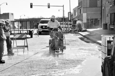 Workers were saw cutting sections of road on Main Street Monday in preparation of water line replacement for the 200, 300 and 400 blocks of Main. Water line replacement is phase one of a downtown revitalization project. Phase Two, sidewalks, is expected t