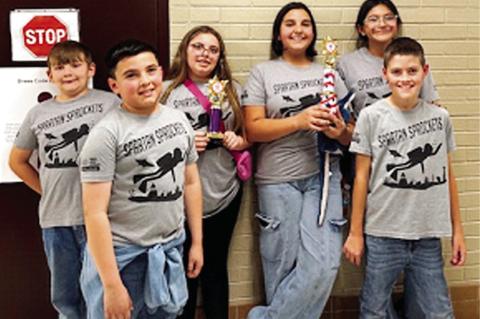 Above, members of the Spartan Sprockets, The Academy of Seminole’s 4th-7th grade robotics club, pose with hardware won at the First Lego League Challenge State Qualifier in Jenks on Oct. 15. By qualifying for state, the Sprockets will now compete agains