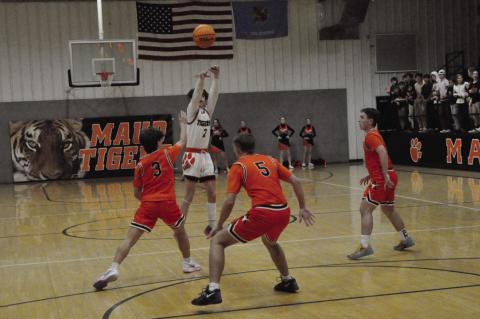 Maud Tiger Colt Abbott takes the shot from three-point range Thursday night. Maud Tigers lost 45-52 to Alex in their first round of the tournament. Staff Photo by Bill Anderson