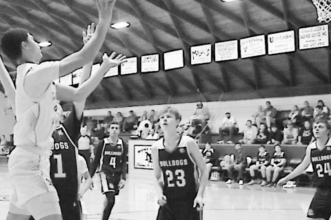 New Lima Falcon Blaze Carter shoots over his defender for the basket. Staff Photo by Andy Wilson