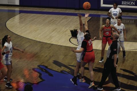 Falconette Cheyenne Deatherage and Lady Tiger Anjli Bahe start the New Lima and Konawa game Thursday afternoon. Staff Photo by Andy Wilson