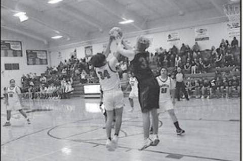 Strother Yellowjacket Parker Moody and Varnum Whippet Adrian Vigil fight for the ball Friday night. Staff Photo by Bill Anderson