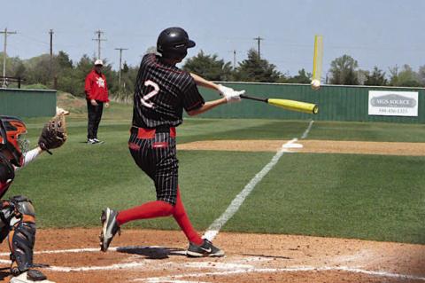 Pictured left is Varnum Whippet Devyn Fullbright sliding into home Wednesday. Pictured below left is Sasakwa Viking Josh Jones knocking one into the outfield Wednesday. Photos by Jeanne Gosa and Bill Anderson