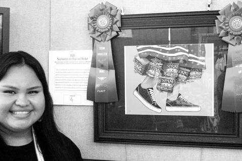 Former Chickasaw Princess Abby Gaines poses with her award-winning graphic arts entry “Spam Shakers.” The piece won second place at the Southeastern Arts Show and Market (SEASAM) conducted each year during Chickasaw Annual Meeting and Festival. (Photo