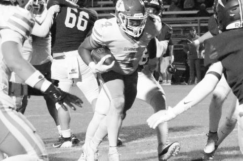 Seminole Chieftain running back Donavin Garfield breaks through the line Friday night. Courtesy Photo by Ben Schatzel