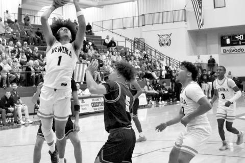 Top photo: Wewoka’s Ladarious Woods goes for the jam in Saturday night’s victory over Pocola to clench the area championship. Above, Nadim Bruner goes under the goal, looking for two points Saturday night in the OG&amp;E Coliseum in Oklahoma City. —