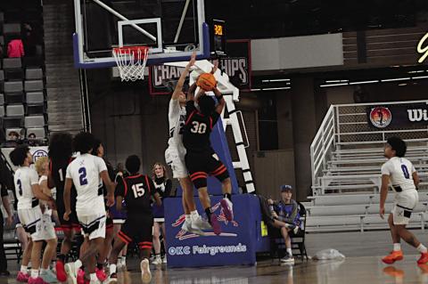 Wewoka Tiger Ladarious Woods goes up against the Hartshorne defender for the shot. Staff Photo by Bill Anderson