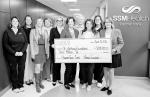 Avedis Foundation board members present a $3 million check to hospital and Cancer Center leaders at SSM Health St. Anthony Hospital-Shawnee. Upgrades will be made to the center to reduce wait times and improve patient throughput. The gift expands access t